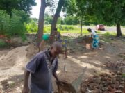 DIN Malawi - the community involved in bring construction materials to site